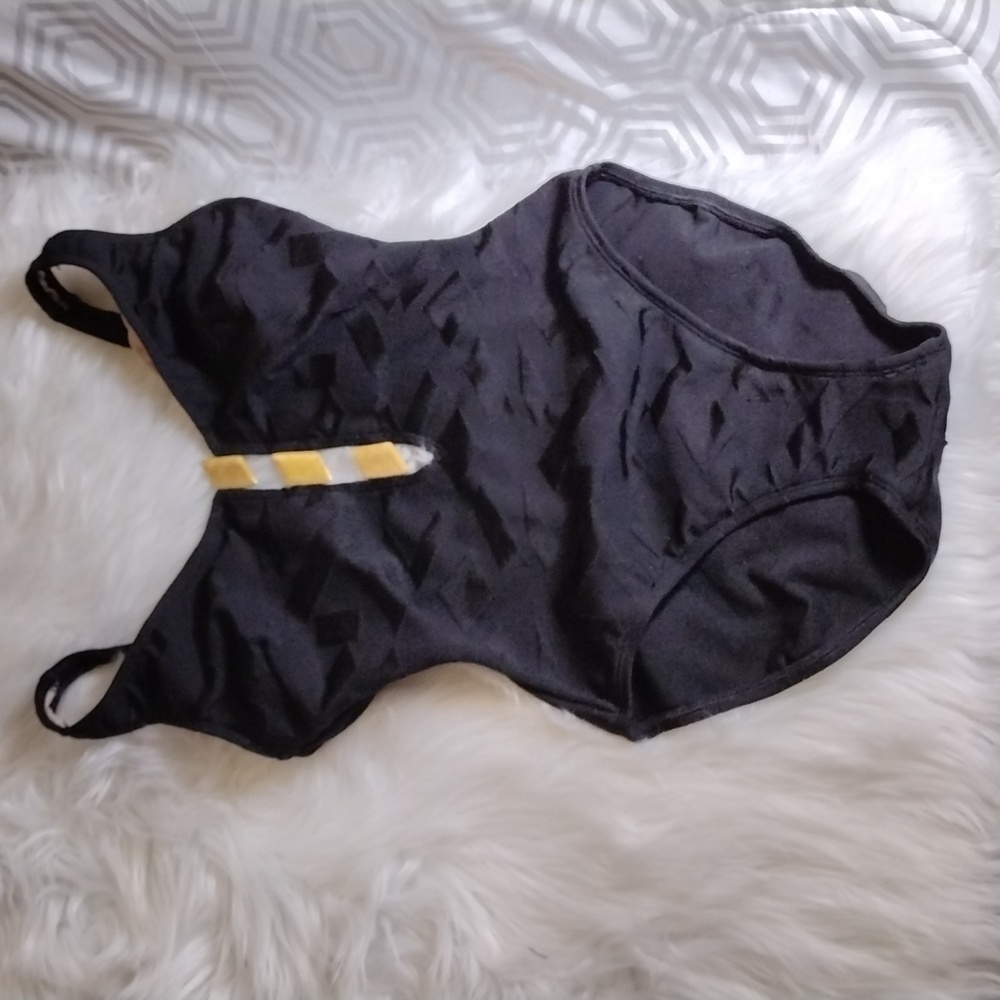 La Blanca estilo one piece black suit with metallic gold center chest cut outs